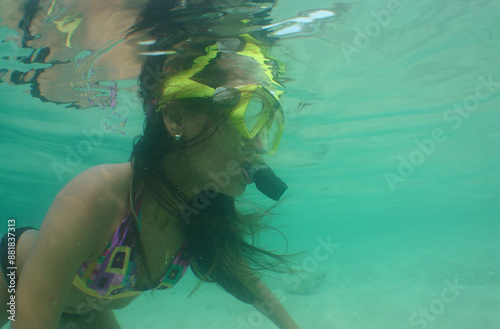 a woman snorkeling on a reef in the caribbean sea photo