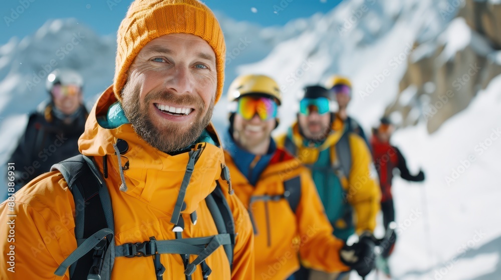A group of hikers is seen wearing orange jackets as they trek through a snowy mountain landscape, showcasing their adventurous spirit and the challenges of winter hiking. A group of hikers is seen wearing orange jackets as they trek through a snowy mountain landscape, showcasing their adventurous spirit and the challenges of winter hiking.