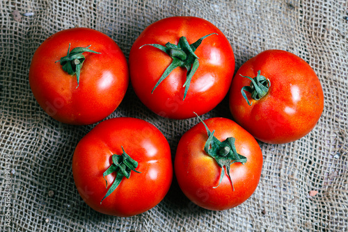 Top view of delicious ripe red cherry tomatoes on soil in farm in daytime