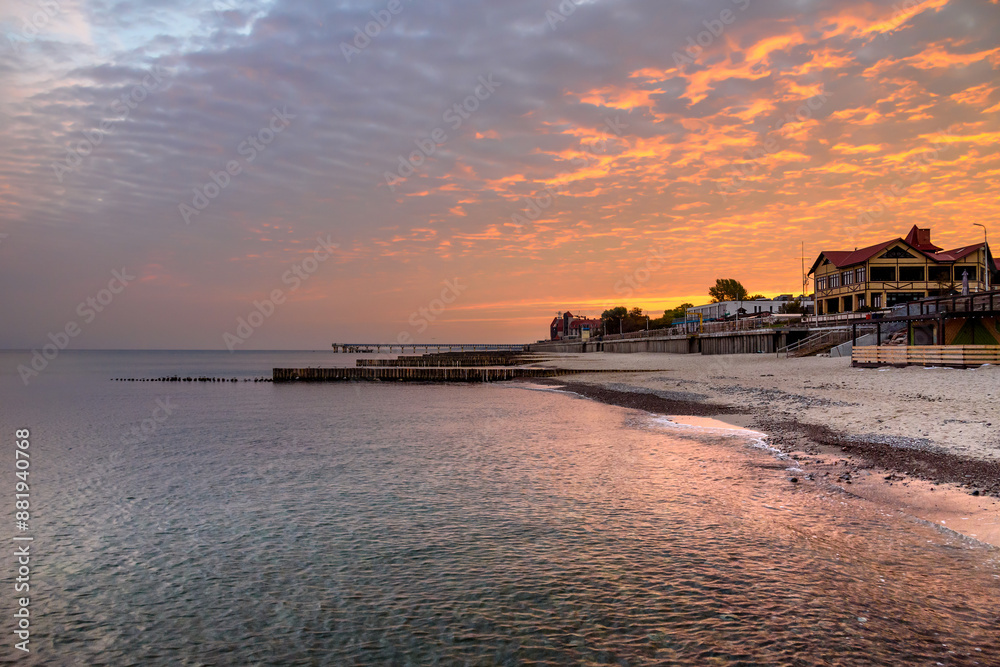 View of sand beach with wooden breakwaters on the Baltic Sea coast on sunrise in Zelenogradsk. Russia