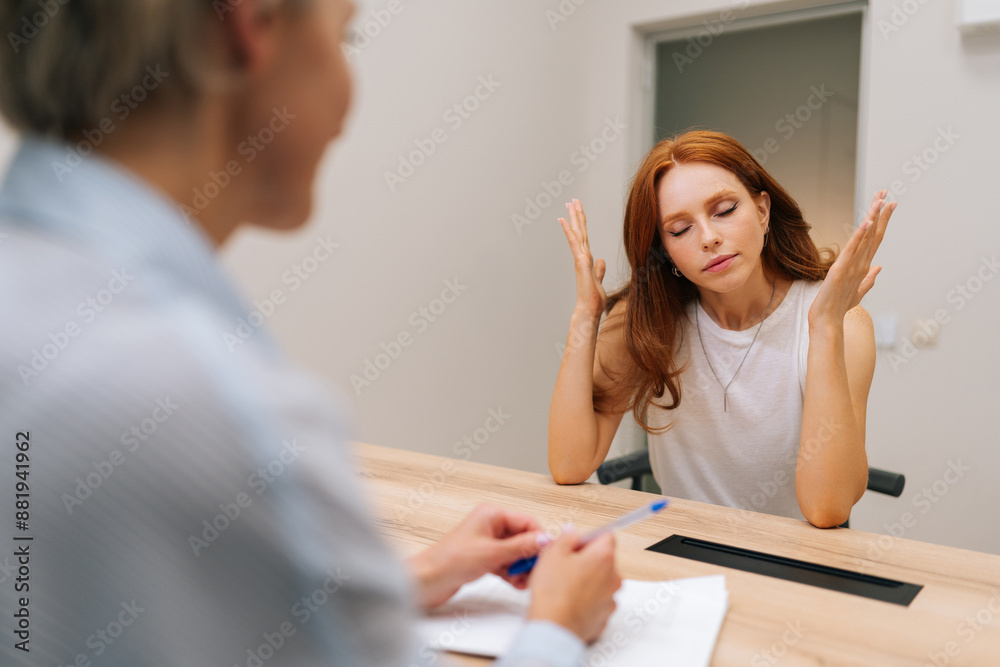 Angry female patient screaming in anger at doctor during medical examination in clinic. Conflict between doctor and patient at table in hospital. Concept of treatment, chronic disease prevention. Angry female patient screaming in anger at doctor during medical examination in clinic. Conflict between doctor and patient at table in hospital. Concept of treatment, chronic disease prevention.
