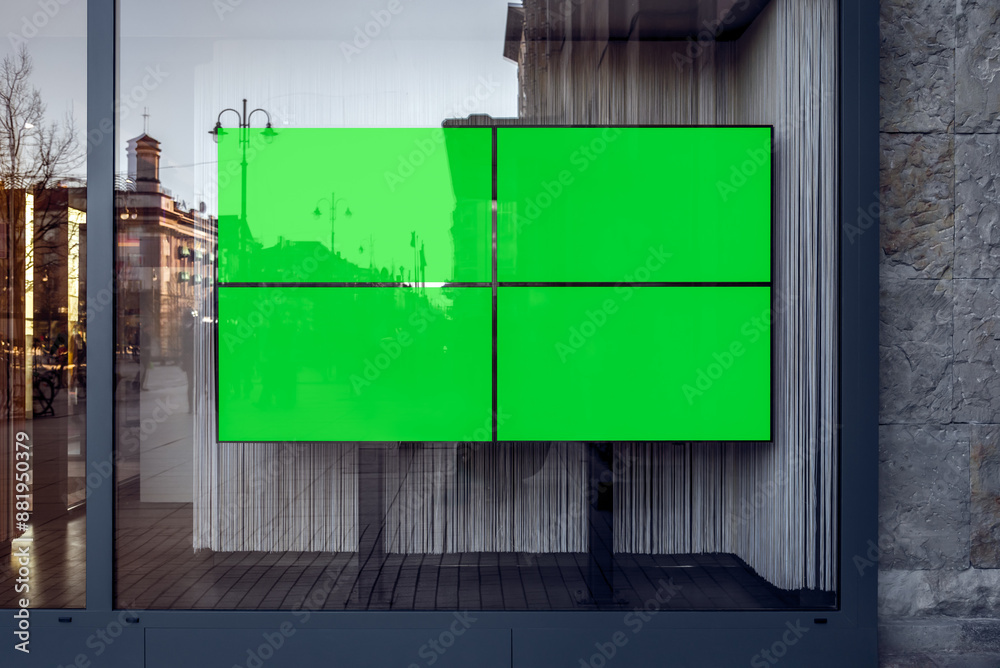 Obraz premium Four Widescreen TVs With Green Screen Mockups For Banners And Branding. Empty Store Showcase With Blank Advertising Billboards