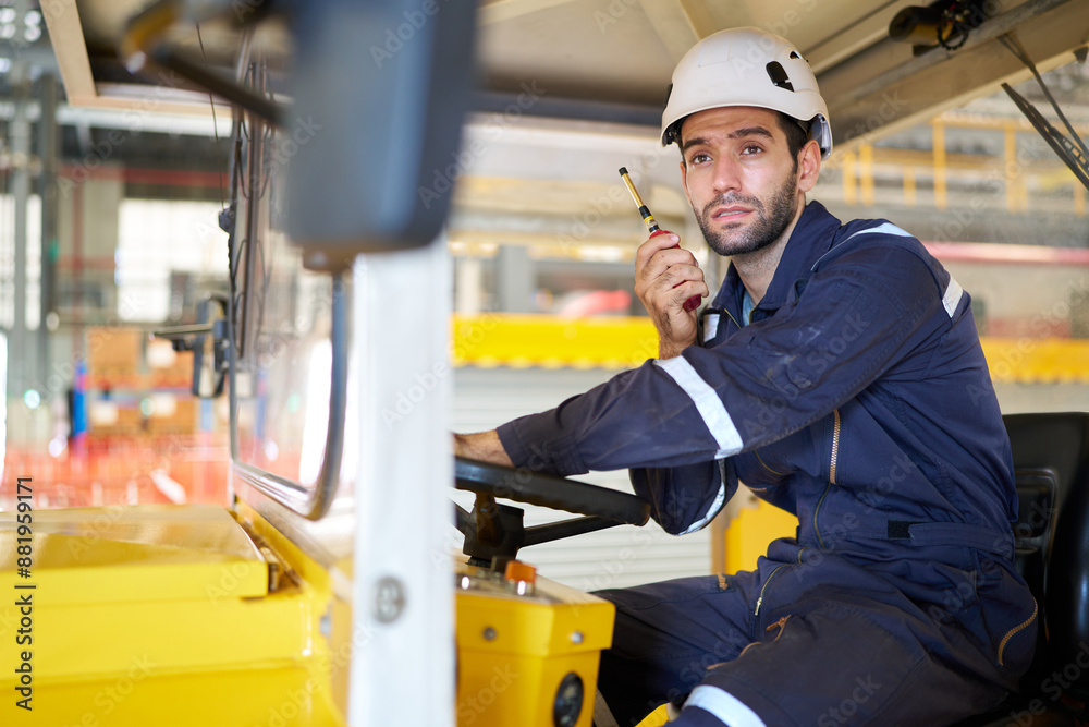 Engineer or worker talking on walkie talkie and driving a car in the factory Engineer or worker talking on walkie talkie and driving a car in the factory