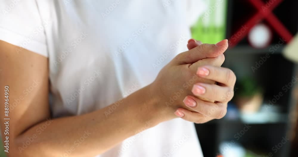 Woman is suffering from pain in hands and arthritis of bones. Closeup of girl massaging overworked hands