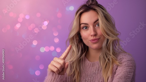 Blonde female beautician pointing with hand with text space on pink, purple with Christmas celebration lights background.