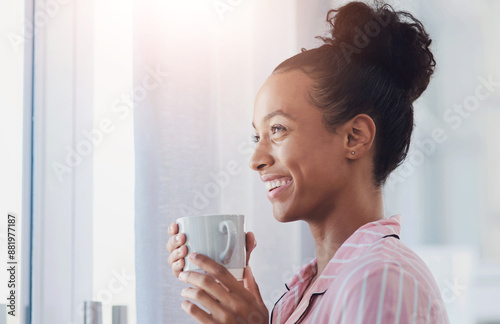Happy woman, thinking and window with coffee for morning, start or new beginning in pajamas at home. Female person with smile in wonder or thought for beverage, drink or caffeine breakfast at house