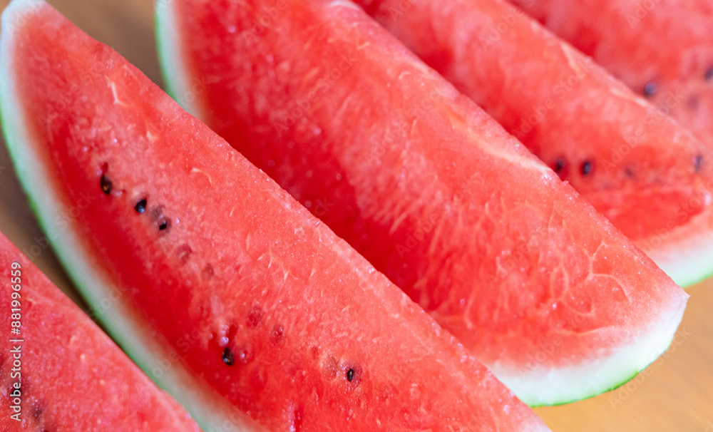 Watermelon slices closeup. Water melon wedges pile, Citrullus lanatus pieces, red wassermelone cuts group Watermelon slices closeup. Water melon wedges pile, Citrullus lanatus pieces, red wassermelone cuts group