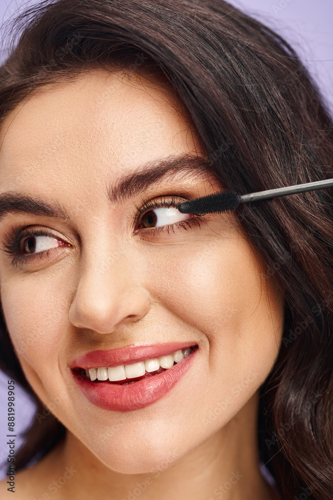 A woman delicately applying mascara with a brush to enhance her eye. A woman delicately applying mascara with a brush to enhance her eye.