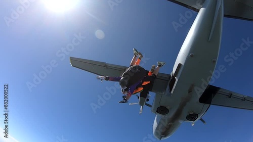 Close-up of a girl making a parachute jump with an instructor
