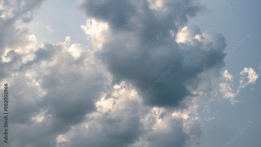 Fototapeta premium Cumulus sunset clouds with sun setting down.