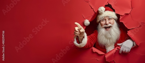 Happy Santa Claus Peeking Through Red Paper