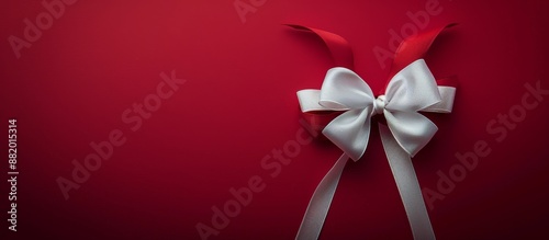 White Satin Bow on Red Background