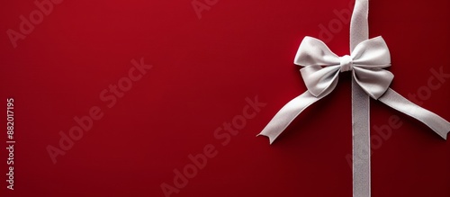 White Satin Bow on Red Background