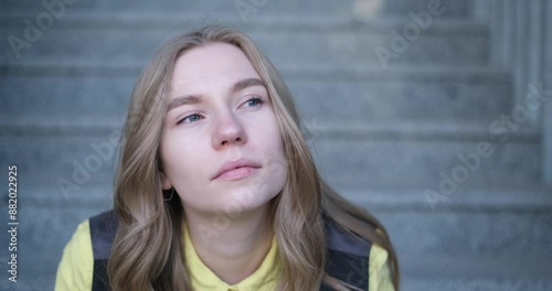 Beautiful blond female office worker on the background of office building . Positive emotions, wearing yellow shirt and jacket. video footage 4k