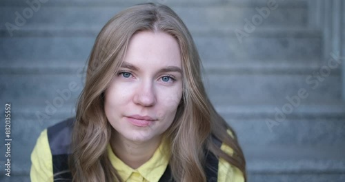 Beautiful blond female office worker on the background of office building . Positive emotions, wearing yellow shirt and jacket. video footage 4k