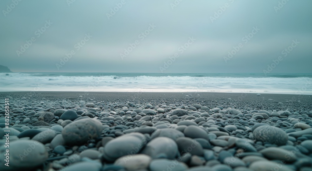 Foggy Morning on a Pebble Beach With Rolling Waves and a Distant Cliff Foggy Morning on a Pebble Beach With Rolling Waves and a Distant Cliff