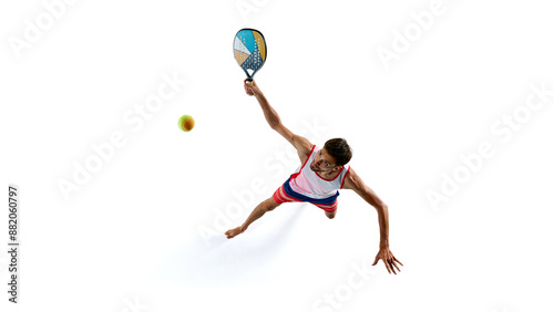 Man in red and blue sports attire playing padel tennis with colorful racket isolated on white background. Concept of sport, active and healthy lifestyle, hobby, games, competition