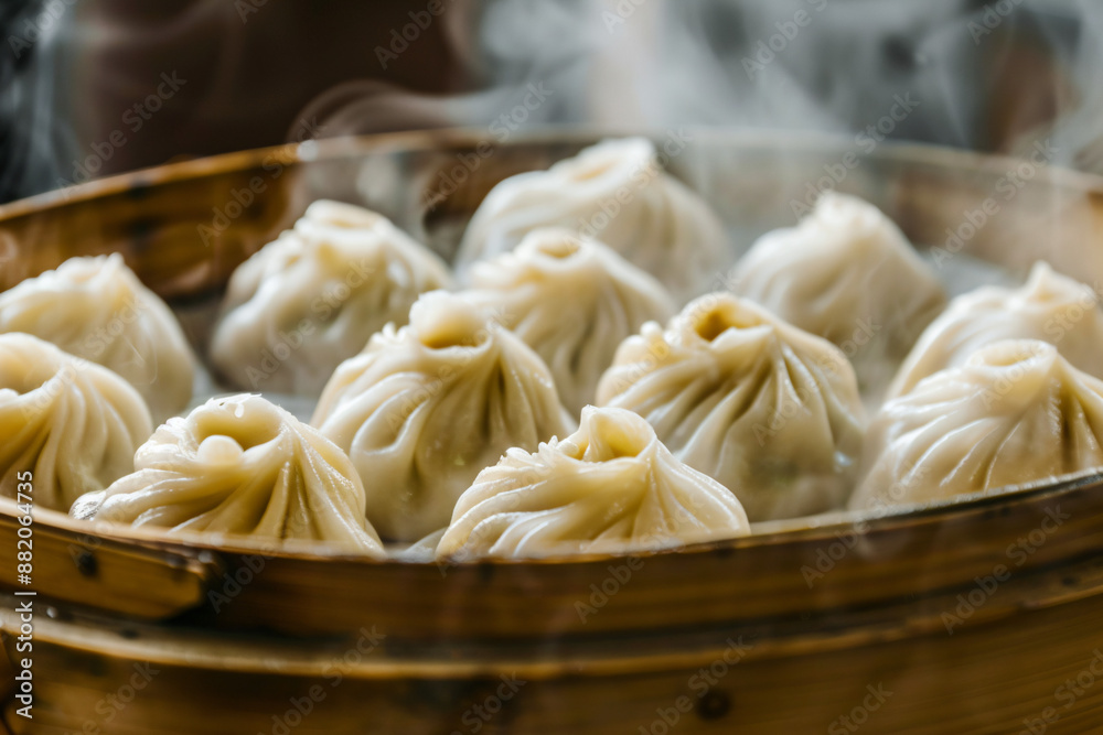 Steaming Chinese Dumplings in a Bamboo Steamer. Steaming Chinese Dumplings in a Bamboo Steamer.