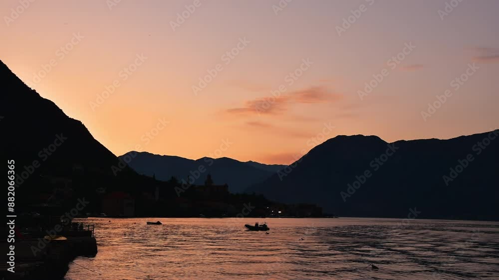 Time lapse boats in Kotor Bay at sunset. Sea and mountain landscape Montenegro, the Balkans, travel Europe Time lapse boats in Kotor Bay at sunset. Sea and mountain landscape Montenegro, the Balkans, travel Europe