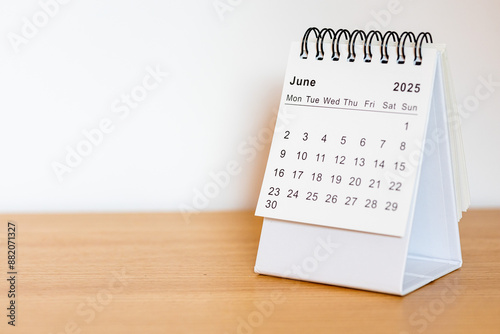 2025 calendar - June month page on the wooden desk
