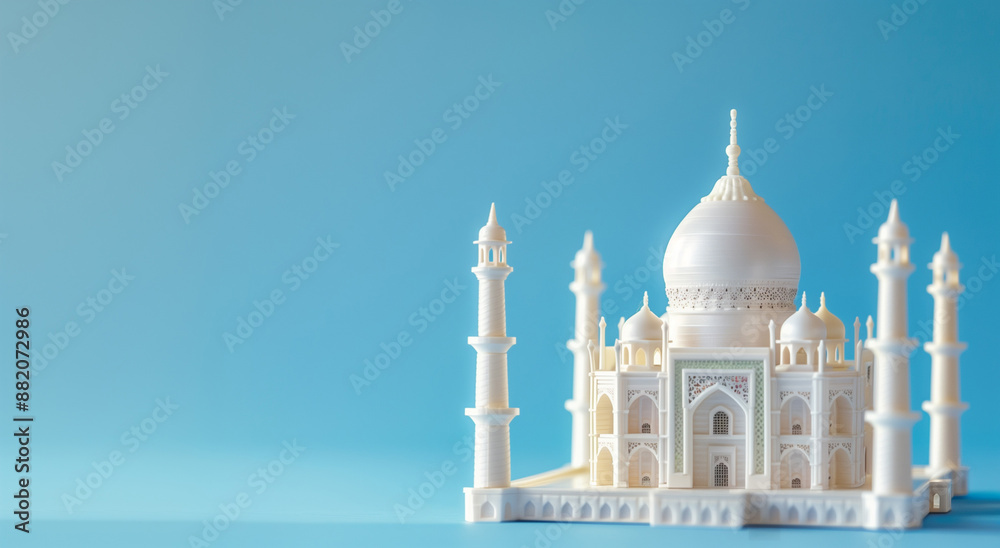 Obraz premium Miniature mosque isolated on blue background with copy space for Islamic celebration day ramadan kareem or eid al fitr adha