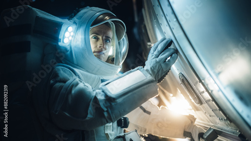 Portrait of Professioanal Astronaut Performing a Routine Maintenance Check Outside a Spacecraft in Zero Gravity in Space. Space Technology, Scientific Exploration, Female Empowerment Concept photo