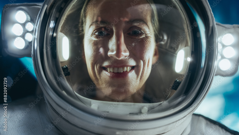 Close Up Portrait of a Courageous Female Astronaut Wearing Helmet and Suit in Outer Space, Floating in Zero Gravity and Looking at Camera in Wonder. Space Travel, Solar System Exploration Concept Close Up Portrait of a Courageous Female Astronaut Wearing Helmet and Suit in Outer Space, Floating in Zero Gravity and Looking at Camera in Wonder. Space Travel, Solar System Exploration Concept