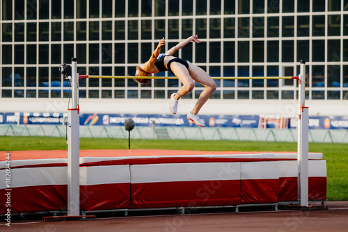 successful attempt high jump female athlete at athletics competition photo