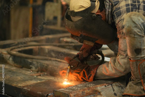 welder working on the factory, Welder erecting technical steel, Industrial steel welder in factory technical, Close-up and wide of a welder wielding sparks stock photo 