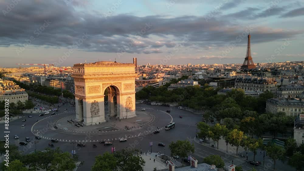 Paris, Arc de Triomphe Triumphal Arch at Chaps Elysees at night, Paris, France. Drone view, Eiffel Tower in the background.  Architecture and landmarks of Paris. Postcard of Paris
