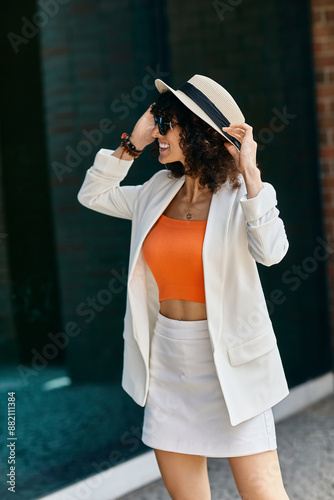 A woman in a white blazer and skirt enjoys her trip through Europe.