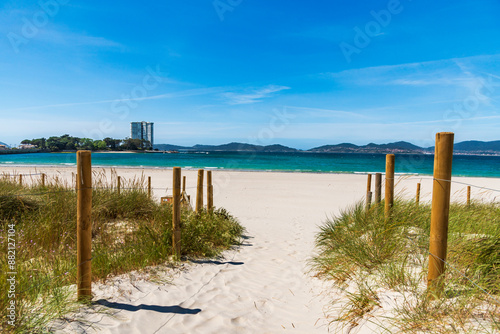 Fenced path over fine sand dunes on O Vao beach, Corujo parish, with views of the island of Toralla, in the Vigo estuary, Pontevedra. photo