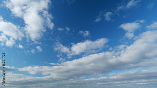 White stratocumulus cloudscape on beautiful sunny clear sky. Tropical summer sunlight. Timelapse.