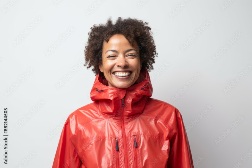 Portrait of a happy afro-american woman in her 50s wearing a lightweight packable anorak isolated on plain white digital canvas Portrait of a happy afro-american woman in her 50s wearing a lightweight packable anorak isolated on plain white digital canvas