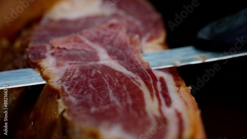 Chef cutting dry-cured spanish ham Jamon.