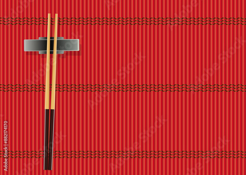 Symbole de la cuisine et des restaurants asiatiques, avec des baguettes posées sur un fond de paille rouge.