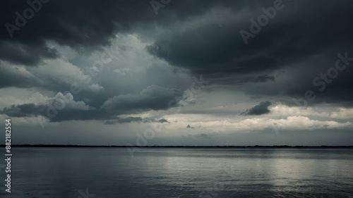 Dramatic and moody image of an overcast stormy sky reflecting over a still lake, capturing a tranquil yet foreboding atmosphere perfect for depicting tension