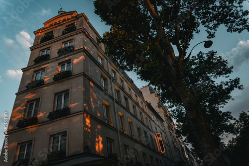Sunset on the Streets of Paris - The warm glow of the setting sun bathing Parisian facades.