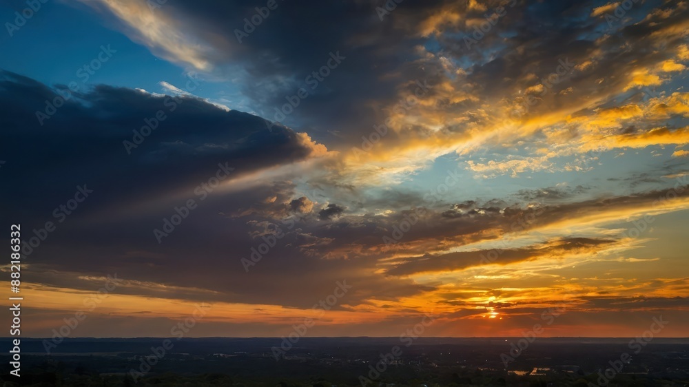 Fototapeta premium A stunning sunset over a vast landscape with dramatic clouds and vibrant colors, capturing the peaceful and serene atmosphere of twilight