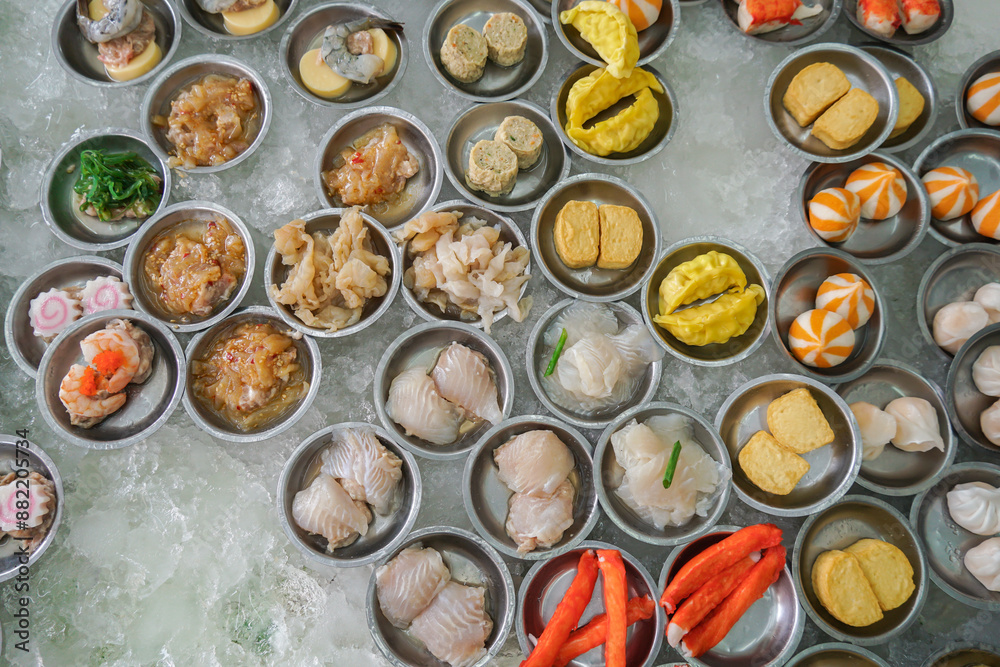 Yumcha, dim sum in bamboo steamer, Chinese cuisine. Variety of dim sum. A cozy dim sum set with a variety of dishes, ready to be enjoyed by diners Yumcha, dim sum in bamboo steamer, Chinese cuisine. Variety of dim sum. A cozy dim sum set with a variety of dishes, ready to be enjoyed by diners