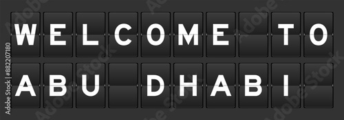 Black color analog flip board with word welcome to abu dhabi on gray background