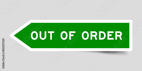 Green color arrow shape sticker label with word out of order on gray background