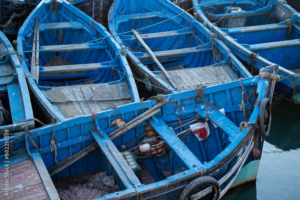 a bunch of blue boats floating in the water a bunch of blue boats floating in the water
