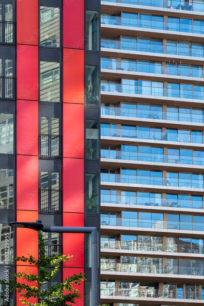 Facade of a colorful building with red panels and glass reflecting blue skies, embodying the blend of aesthetics and functionality in modern urban architecture in Rotterdam Facade of a colorful building with red panels and glass reflecting blue skies, embodying the blend of aesthetics and functionality in modern urban architecture in Rotterdam