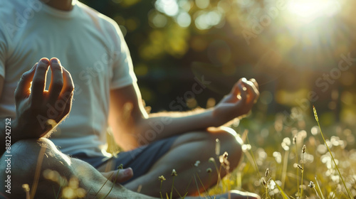 Man meditating in a sunlit meadow, hands in mudra position, capturing the essence of tranquility and connection with nature.