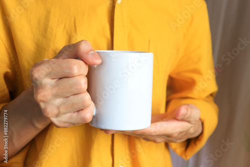 person holding cup of coffee mockup