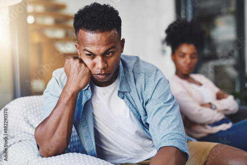 Angry, man and couple with conflict on sofa for cheating, betrayal and affair with ignore or breakup in home. Black people, frustrated and toxic marriage in living room with disagreement and argument