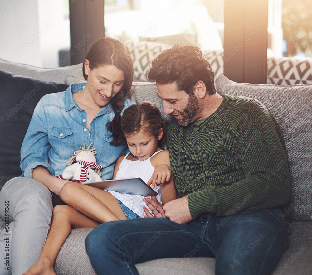 Family, child and internet with tablet on sofa, relax and happy for bonding with streaming on app. Man, woman and girl or daughter in home with digital touchscreen for movie, film or ebook for story Family, child and internet with tablet on sofa, relax and happy for bonding with streaming on app. Man, woman and girl or daughter in home with digital touchscreen for movie, film or ebook for story