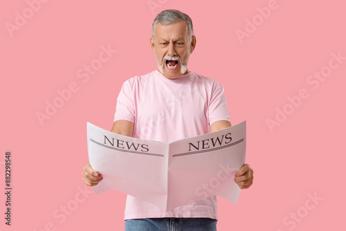Shocked senior man with new...