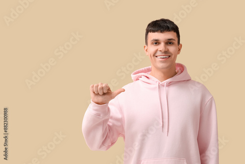 Smiling young man in pink h...